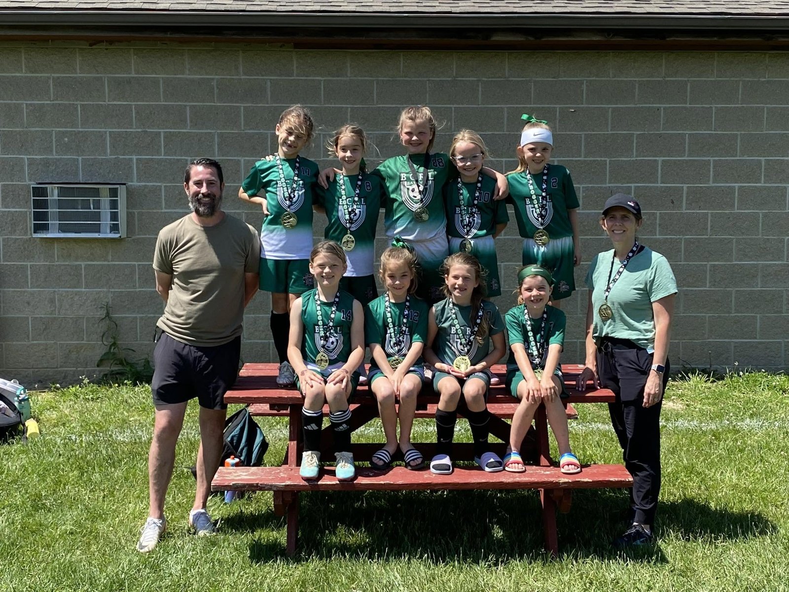 BCRL girls soccer team with medals and coaches