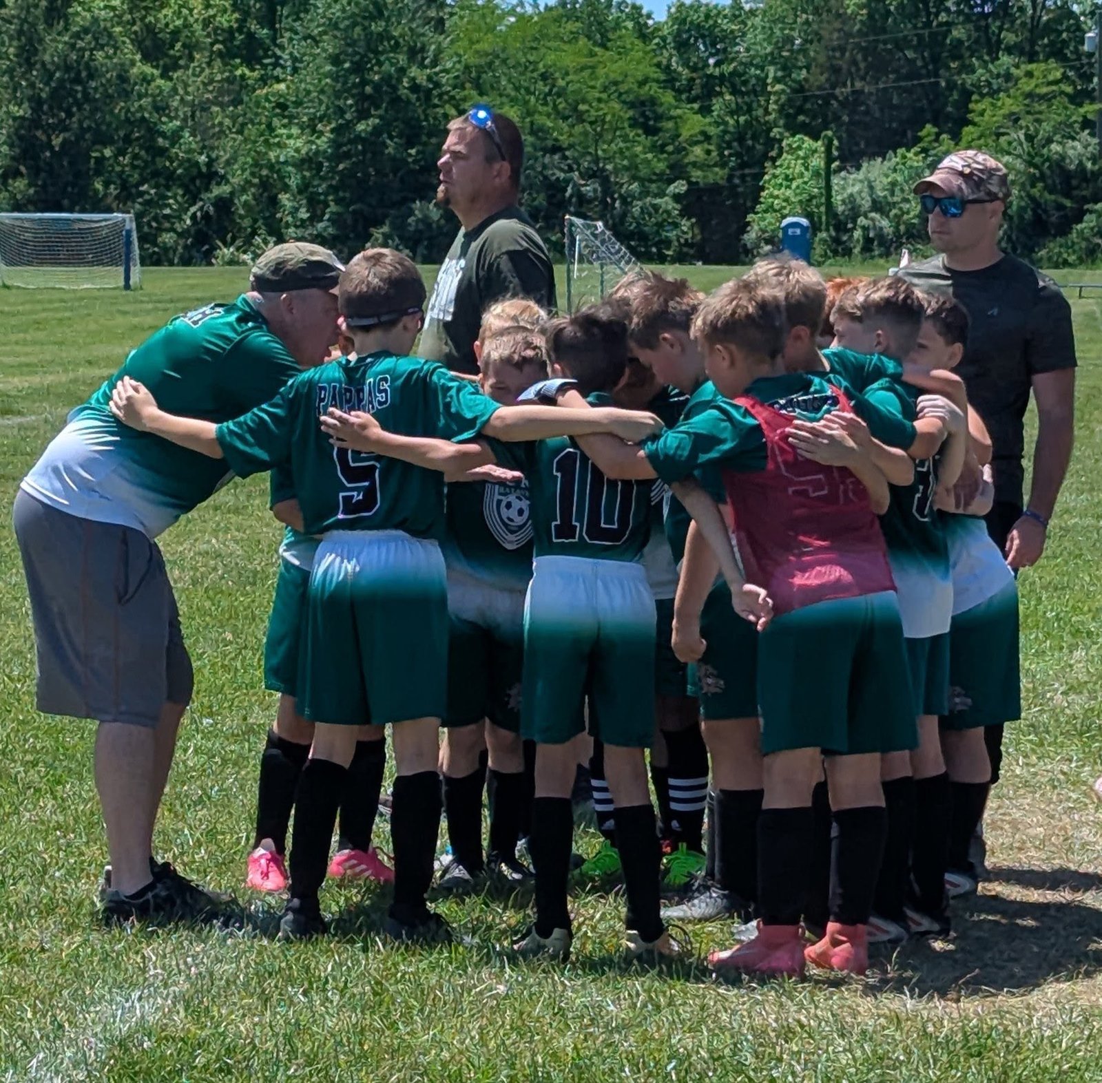 BCRL soccer team huddle with coaches